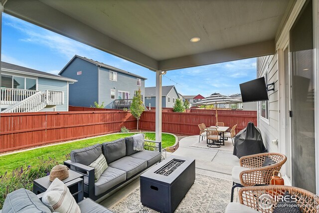 view of patio / terrace with an outdoor living space with a fire pit