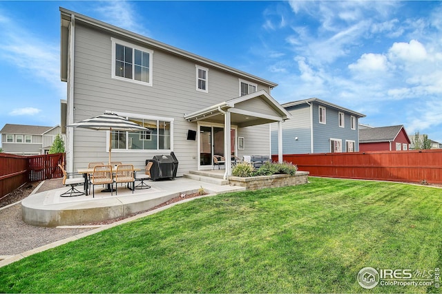 back of house featuring a lawn and a patio area