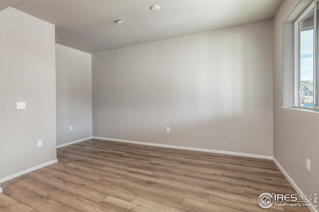 unfurnished room with wood-type flooring