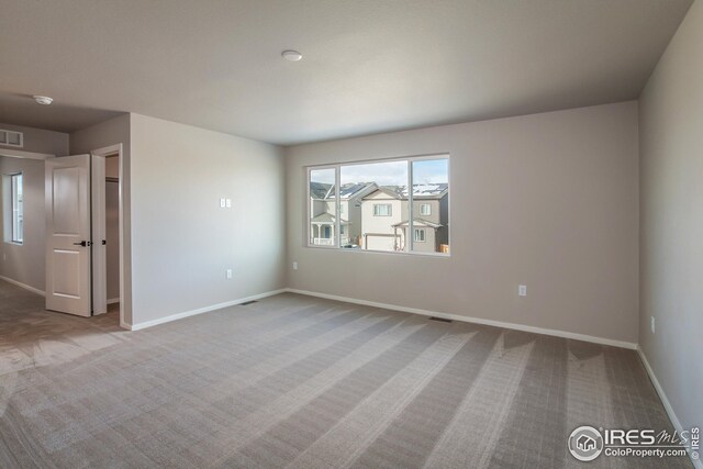 empty room with light colored carpet