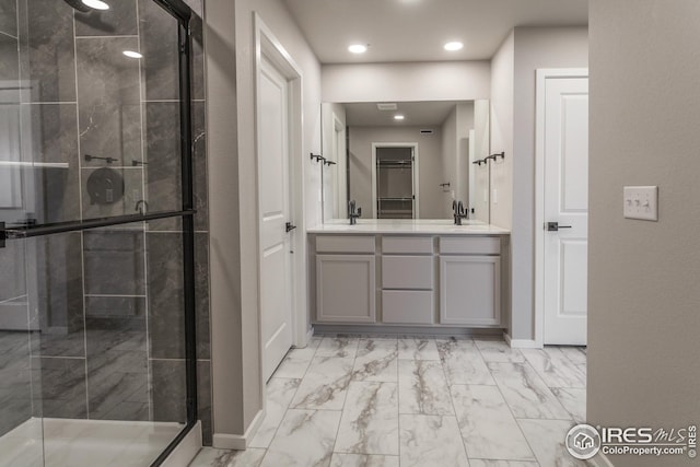 bathroom featuring vanity and a shower with door