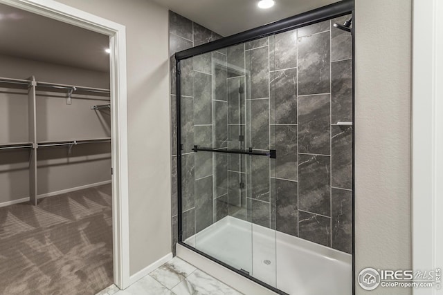 bathroom featuring a shower with shower door