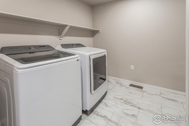 clothes washing area with washer and dryer