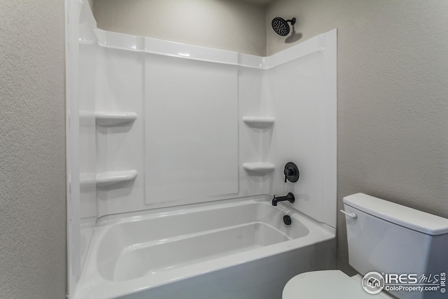 bathroom featuring shower / bathing tub combination and toilet