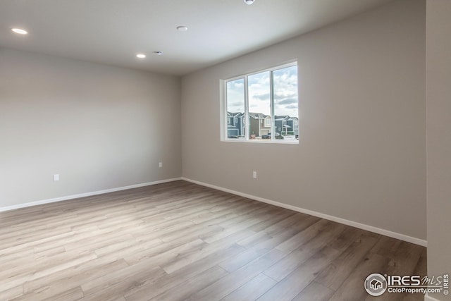 unfurnished room with light wood-type flooring