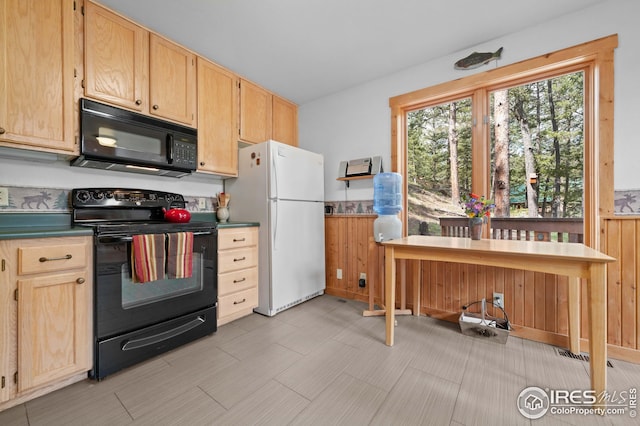 kitchen with black appliances and light brown cabinetry