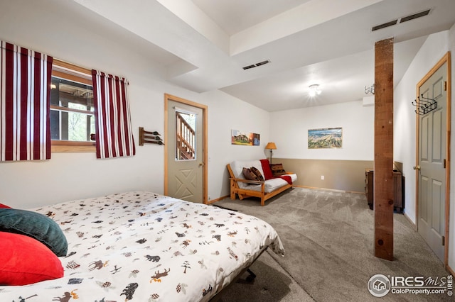 carpeted bedroom featuring baseboards and visible vents