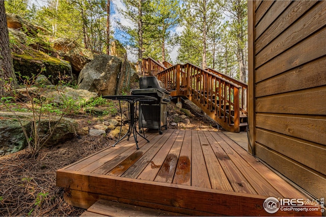 wooden terrace featuring stairs