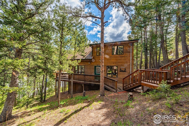 back of property with a wooden deck