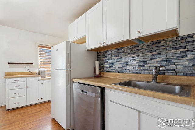 kitchen with light hardwood / wood-style floors, dishwasher, decorative backsplash, white cabinets, and sink