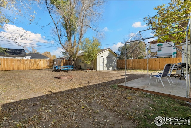 view of yard featuring a storage unit and a deck