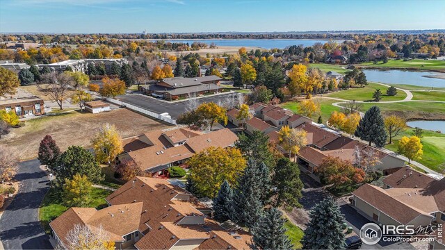 drone / aerial view with a water view and a residential view