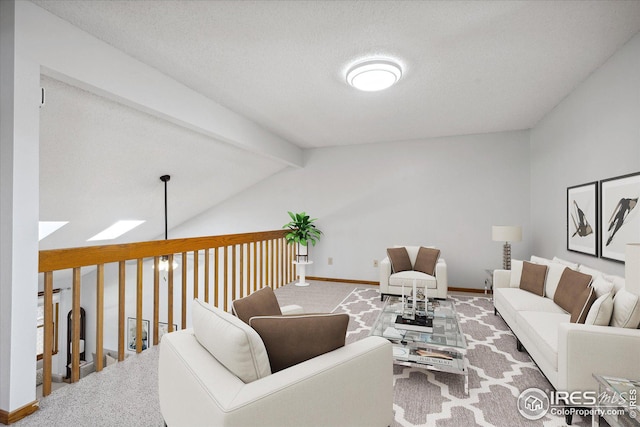 living room with vaulted ceiling with beams, a textured ceiling, carpet flooring, and baseboards