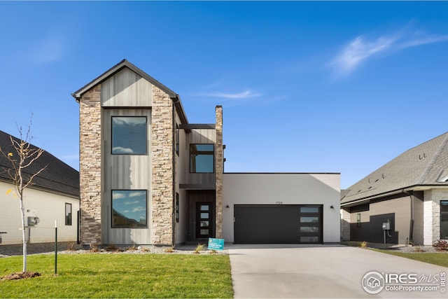 contemporary home featuring driveway, a front lawn, board and batten siding, and an attached garage