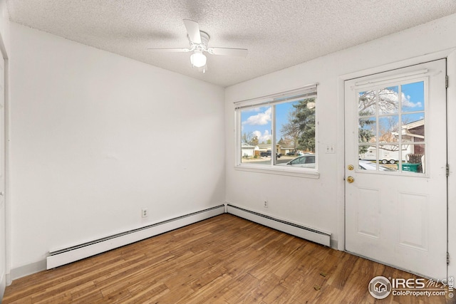 interior space featuring hardwood / wood-style floors, ceiling fan, and a textured ceiling