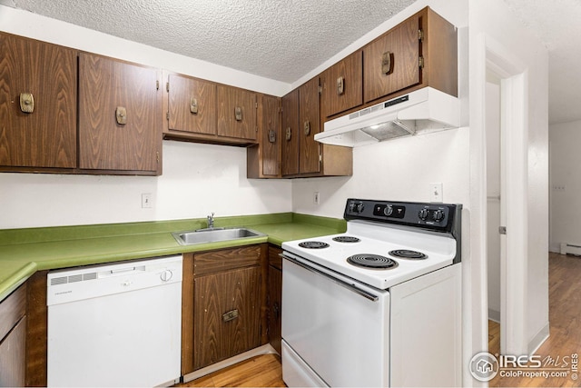 kitchen featuring a textured ceiling, sink, a baseboard heating unit, white appliances, and light hardwood / wood-style flooring