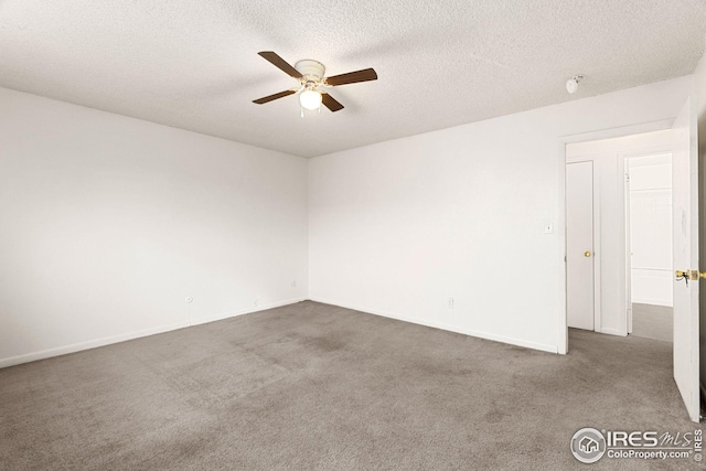 carpeted spare room with a textured ceiling and ceiling fan