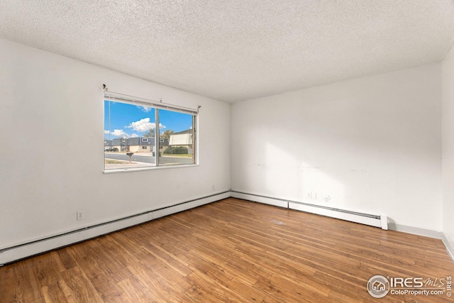 spare room with wood-type flooring and a textured ceiling