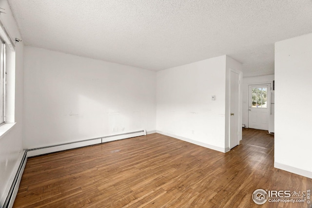 unfurnished room with a textured ceiling, hardwood / wood-style floors, and a baseboard radiator