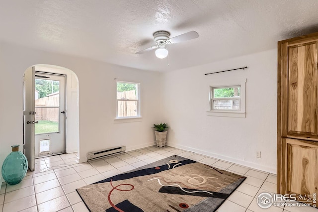 1127 W Mulberry St, Fort Collins, CO 80521 - doorway to outside with a baseboard heating unit, healthy amount of natural light, light tile patterned flooring, a ceiling fan, and a textured ceiling