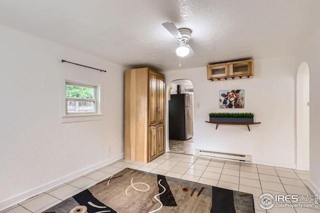 1127 W Mulberry St, Fort Collins, CO 80521 - foyer with arched walkways, a baseboard radiator, light tile patterned floors, baseboards, and a textured ceiling
