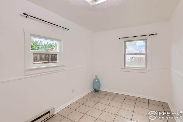 1127 W Mulberry St, Fort Collins, CO 80521 - unfurnished room featuring healthy amount of natural light, baseboard heating, baseboards, and light tile patterned flooring