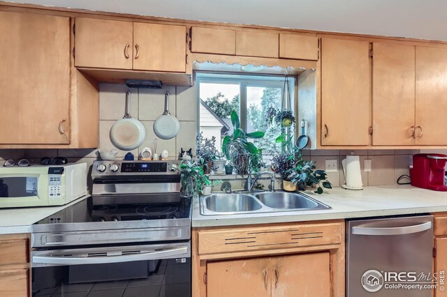 1127 W Mulberry St, Fort Collins, CO 80521 - kitchen with stainless steel appliances, a sink, light countertops, and backsplash