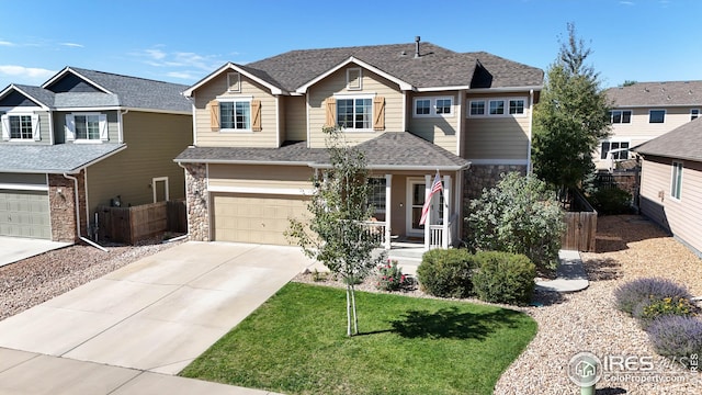 craftsman-style home featuring a garage, a front yard, and a porch