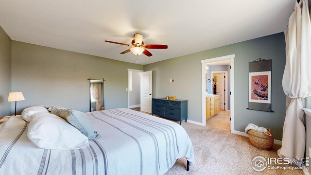 carpeted bedroom with ceiling fan and ensuite bath