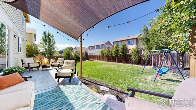 view of yard featuring a patio area, an outdoor hangout area, and a playground