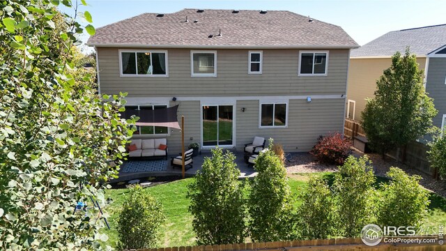 back of property featuring a patio area, outdoor lounge area, and a lawn