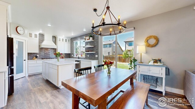 dining space featuring dark hardwood / wood-style flooring and a notable chandelier