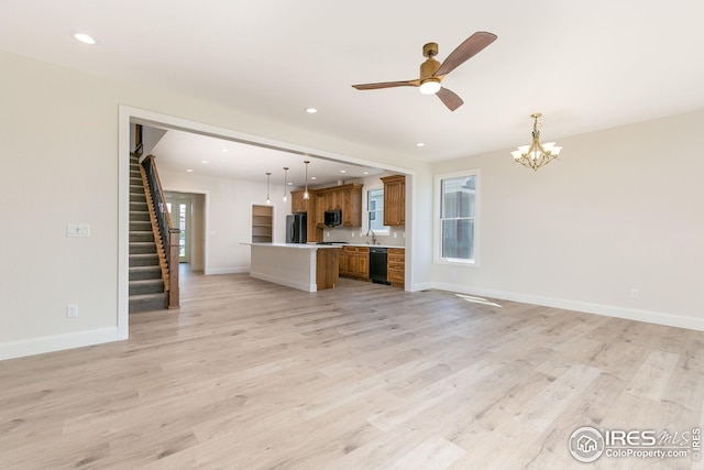 unfurnished living room featuring light wood-style floors, recessed lighting, stairway, and baseboards