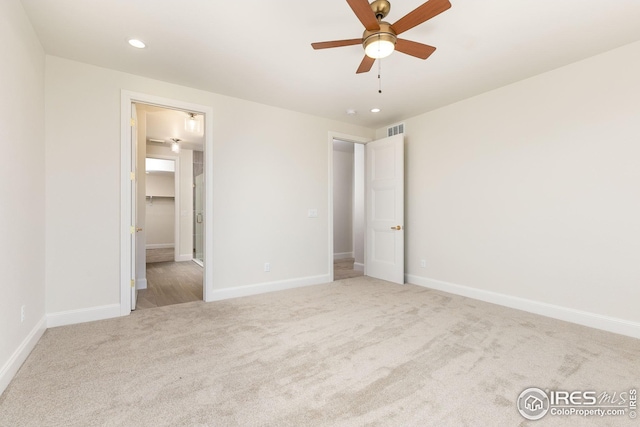 unfurnished bedroom with visible vents, baseboards, carpet, a spacious closet, and recessed lighting