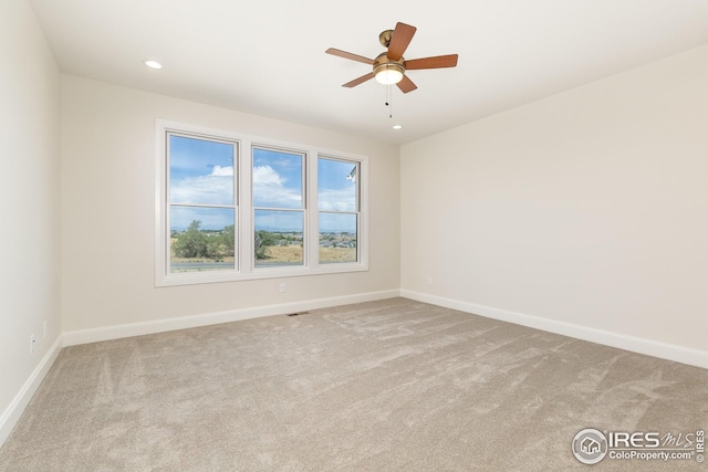 spare room featuring recessed lighting, carpet, and baseboards