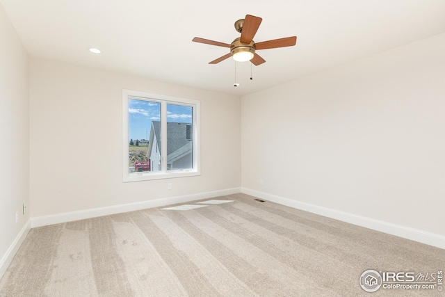 unfurnished room featuring a ceiling fan, recessed lighting, light colored carpet, and baseboards