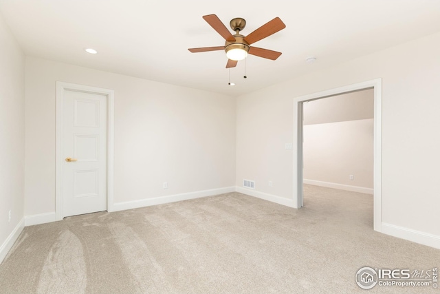 carpeted empty room featuring a ceiling fan, recessed lighting, visible vents, and baseboards