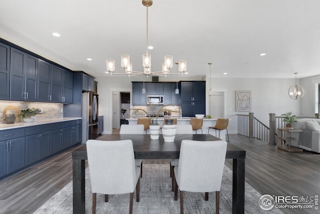 dining area featuring an inviting chandelier, dark wood-type flooring, and recessed lighting