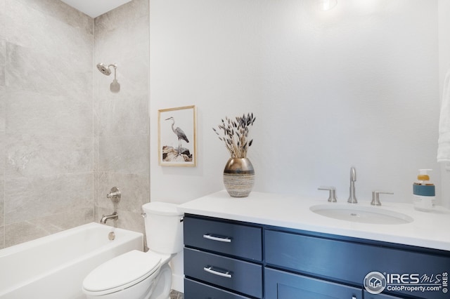 bathroom featuring washtub / shower combination, vanity, and toilet