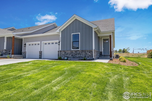 view of front of property with driveway, board and batten siding, an attached garage, and a front yard