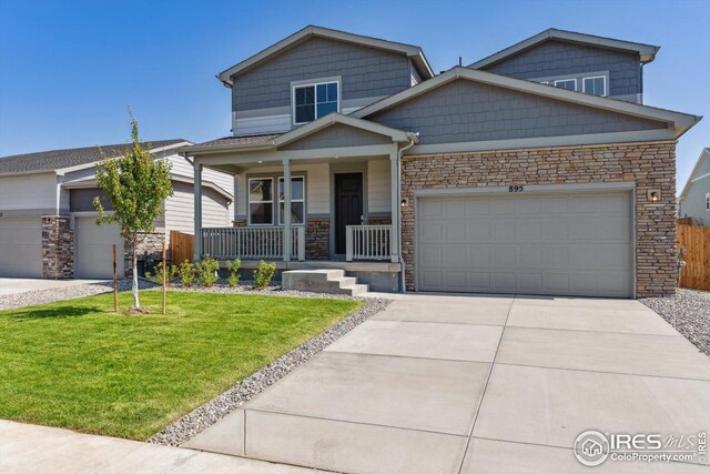 craftsman-style house featuring a front lawn, a garage, and a porch