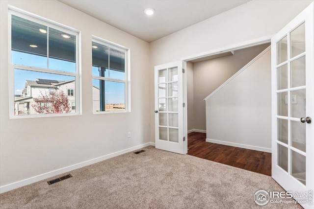 spare room with french doors and carpet flooring