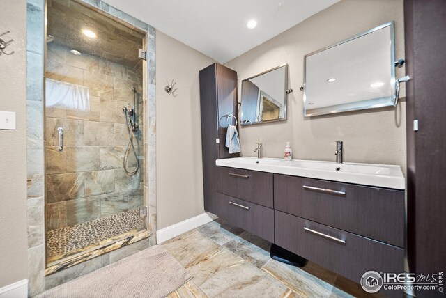 bathroom with vanity and a shower with shower door