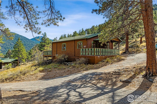 view of front of house featuring a deck with mountain view