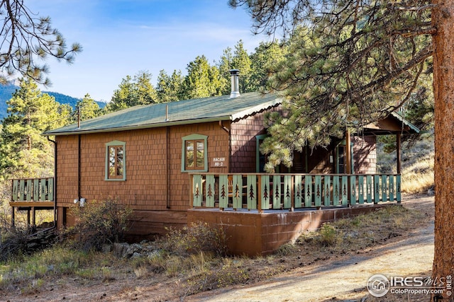 view of side of property featuring a wooden deck