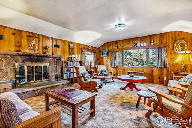 living room featuring light carpet, a stone fireplace, lofted ceiling, and wood walls