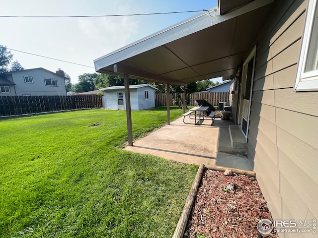 view of yard with an outdoor structure and a patio area