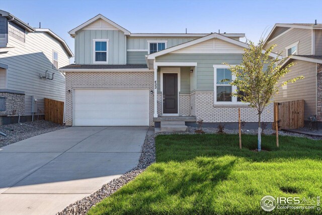 view of front of home with a garage and a front lawn