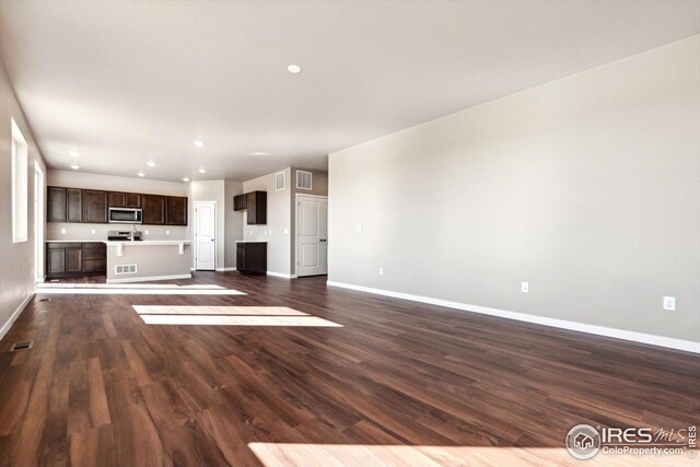 unfurnished living room with dark hardwood / wood-style floors