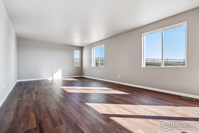 unfurnished room featuring dark hardwood / wood-style floors